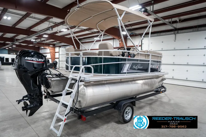 Slide: The Image of 2024 SunChaser 16 Vista pontoon boat with Mercury engine in indoor showroom. - 8
