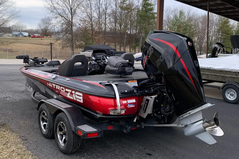 Slide: The Image of 2019 Nitro Z19 Pro bass boat with powerful outboard motor, parked on a trailer. - 3