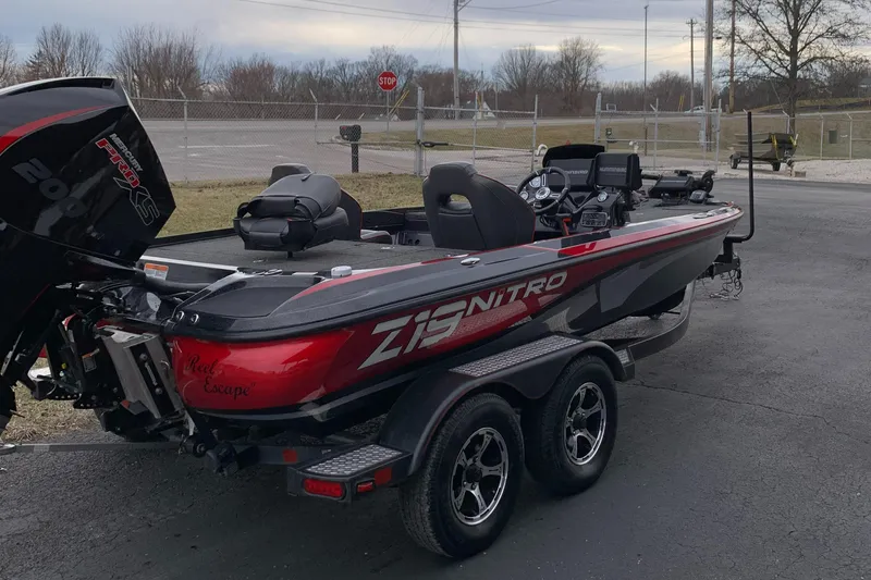Slide: The Image of 2019 Nitro Z19 Pro boat on trailer, red and black design, parked outdoors. - 4