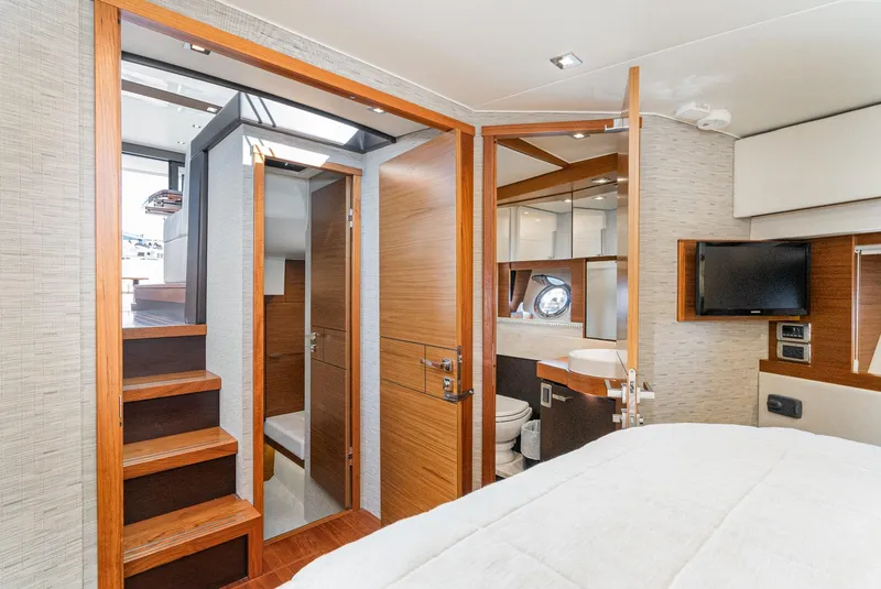 Slide: The Image of Interior of 2017 Tiara Yachts 44 Coupe, featuring a cozy cabin and modern bathroom. - 11
