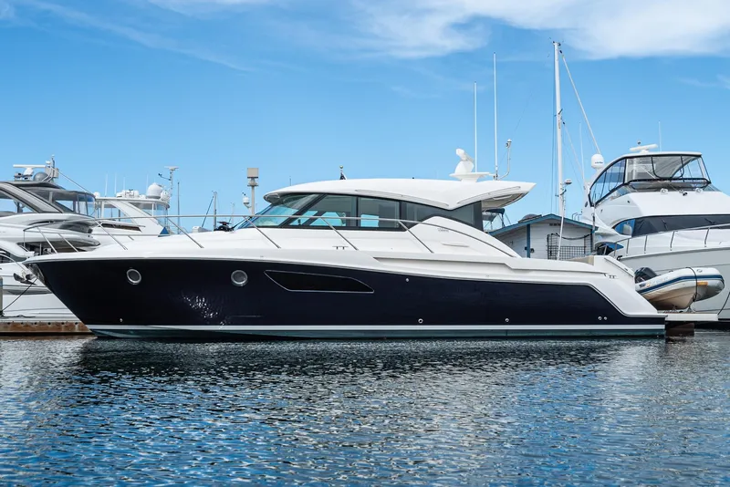 Slide: The Image of 2017 Tiara Yachts 44 Coupe docked in marina, sleek design, clear blue sky. - 12