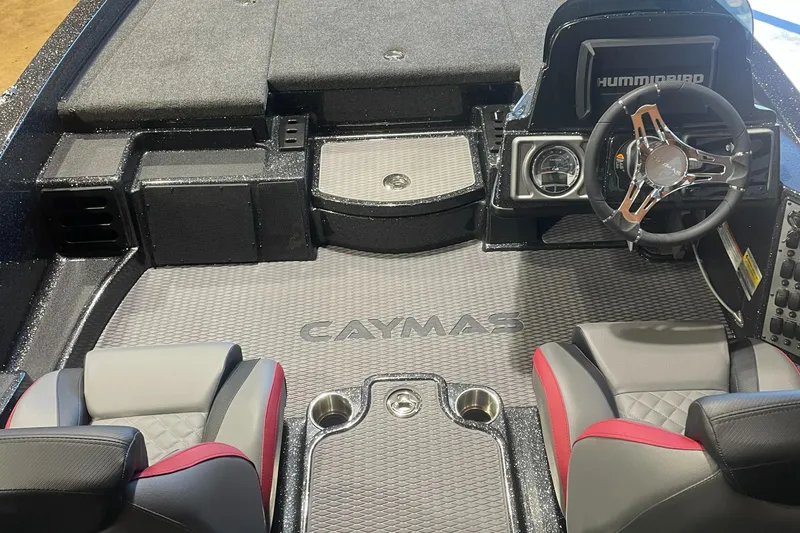 Slide: The Image of 2025 Caymas CX 18 Pro boat interior with steering wheel and seating. - 3