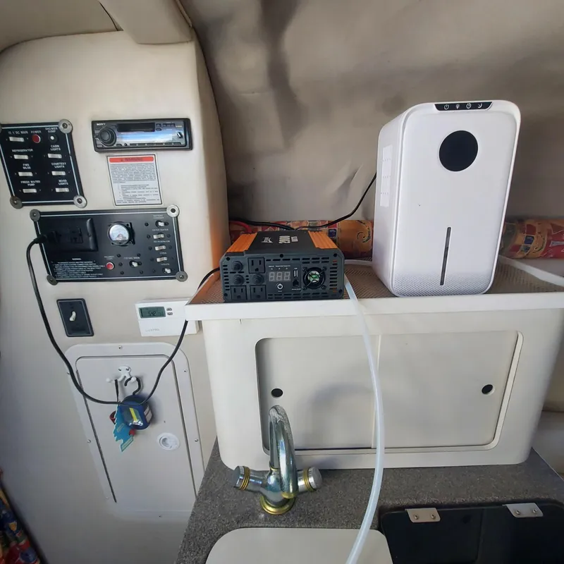 Slide: The Image of Interior of a 2000 Crownline 242 CR boat with control panel and appliances. - 10