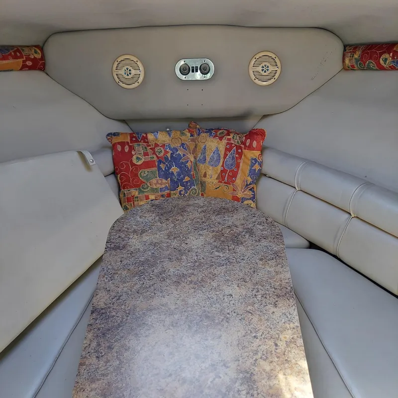 Slide: The Image of Interior cabin of 2000 Crownline 242 CR boat with colorful cushions and table. - 16