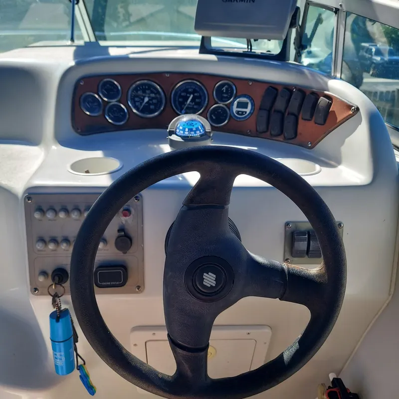 Slide: The Image of Steering wheel and dashboard of a 2000 Crownline 242 CR boat. - 19