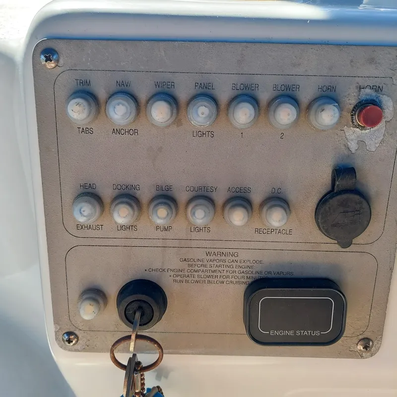 Slide: The Image of Control panel of a 2000 Crownline 242 CR boat with various switches and ignition keys. - 20