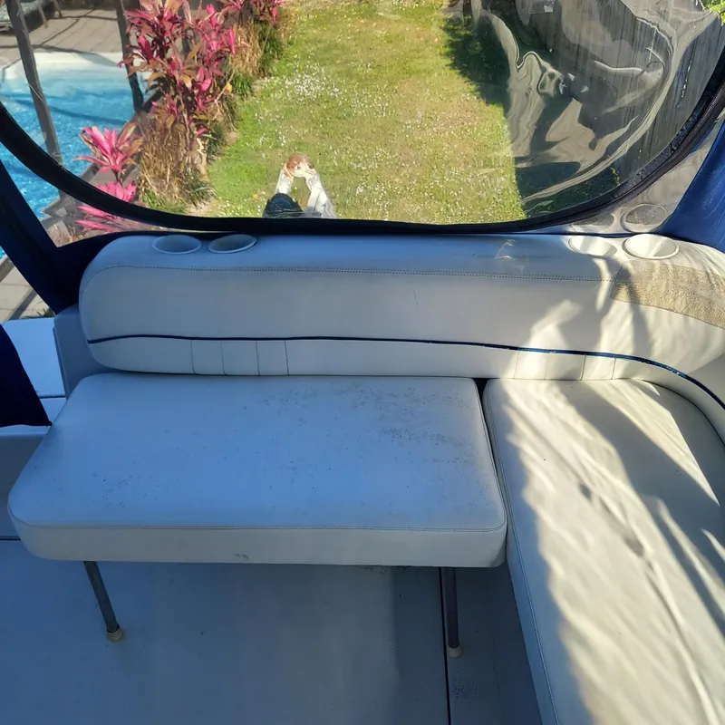 Slide: The Image of Crownline 242 CR 2000 boat interior with white seating and cup holders. - 23