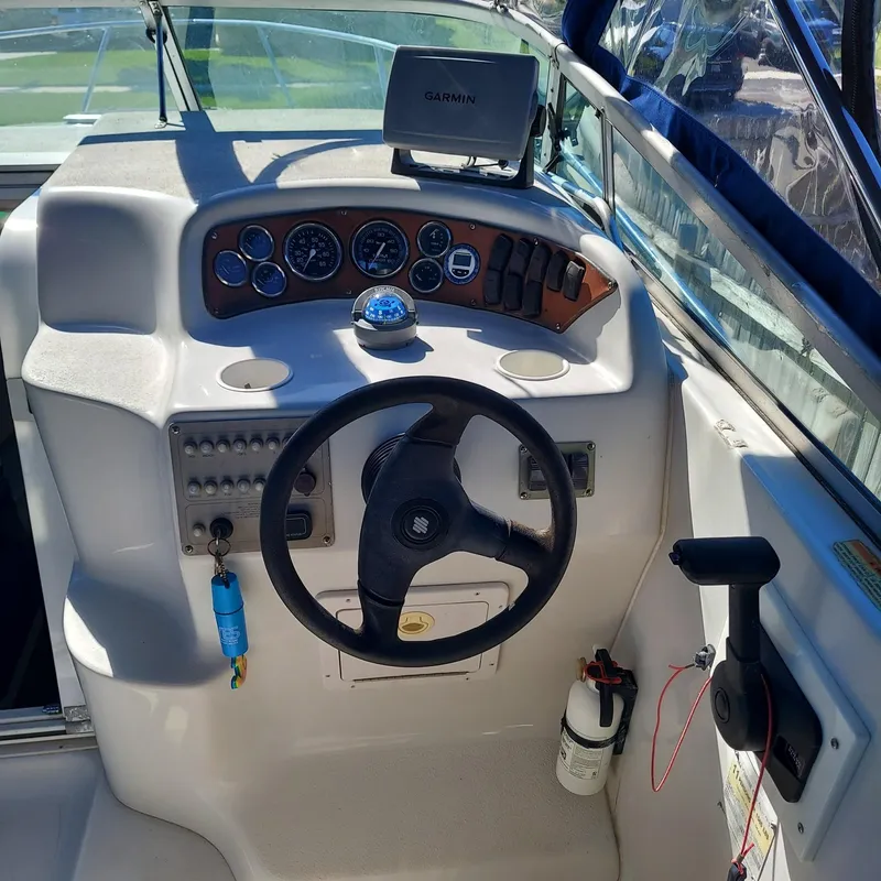 Slide: The Image of Crownline 242 CR 2000 boat dashboard with steering wheel and navigation equipment. - 24