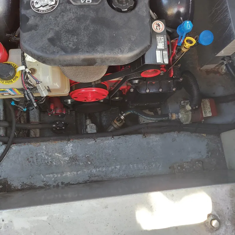 Slide: The Image of Engine compartment of a 2000 Crownline 242 CR boat, featuring a V8 engine. - 27