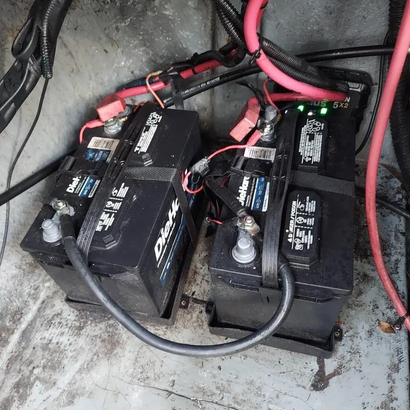 Slide: The Image of Dual batteries in a 2000 Crownline 242 CR boat, connected with red and black cables. - 28