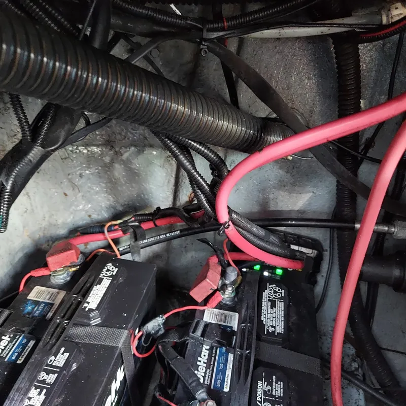 Slide: The Image of Battery compartment of a 2000 Crownline 242 CR boat with wiring and connections. - 29