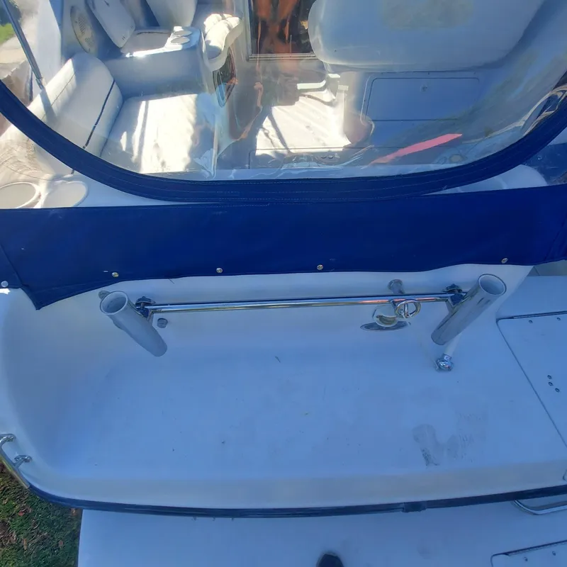 Slide: The Image of Crownline 242 CR 2000 boat interior with seating and rod holders. - 30