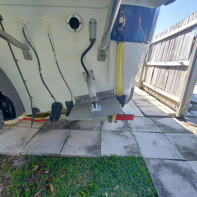 Slide: The Image of Rear view of a 2000 Crownline 242 CR boat on a paved surface. - 36