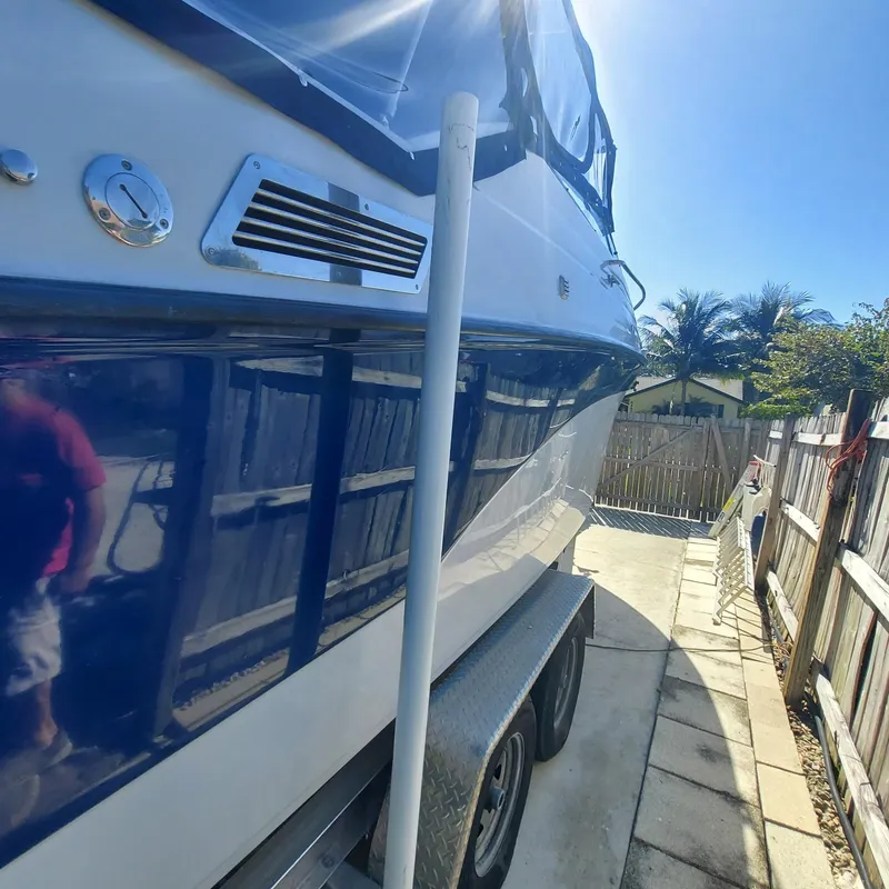 Slide: The Image of 2000 Crownline 242 CR boat on trailer, parked in sunny driveway. - 41