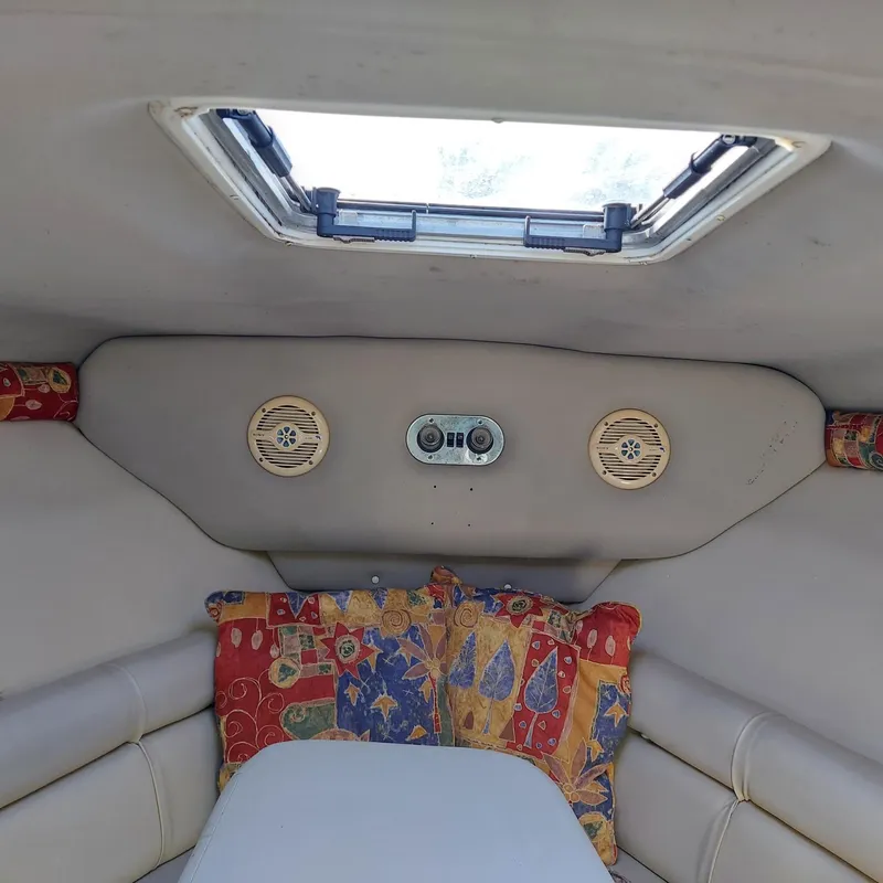 Slide: The Image of Interior cabin of 2000 Crownline 242 CR boat with colorful cushions and speakers. - 5