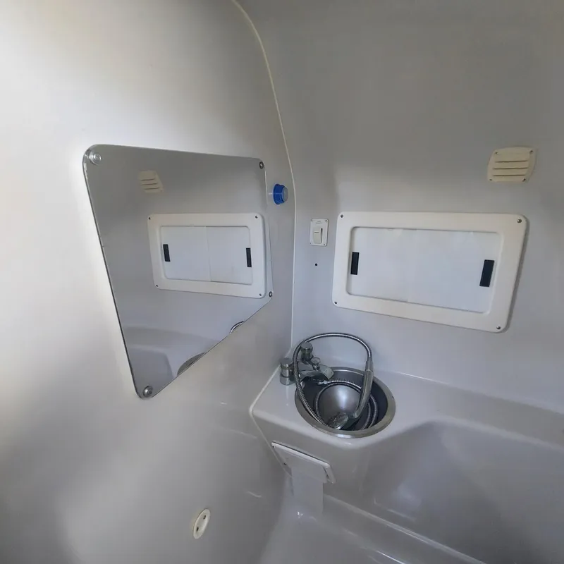 Slide: The Image of Interior of 2000 Crownline 242 CR boat bathroom with sink and mirror. - 9
