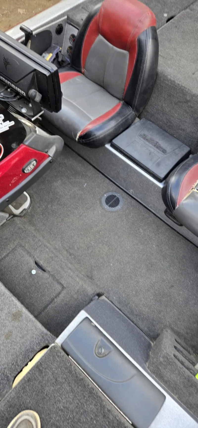 Slide: The Image of 2013 Skeeter ZX20 boat interior with red and gray seating and carpeted flooring. - 11