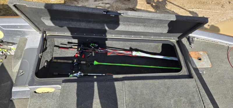 Slide: The Image of 2013 Skeeter ZX20 boat storage compartment with fishing rods. - 14