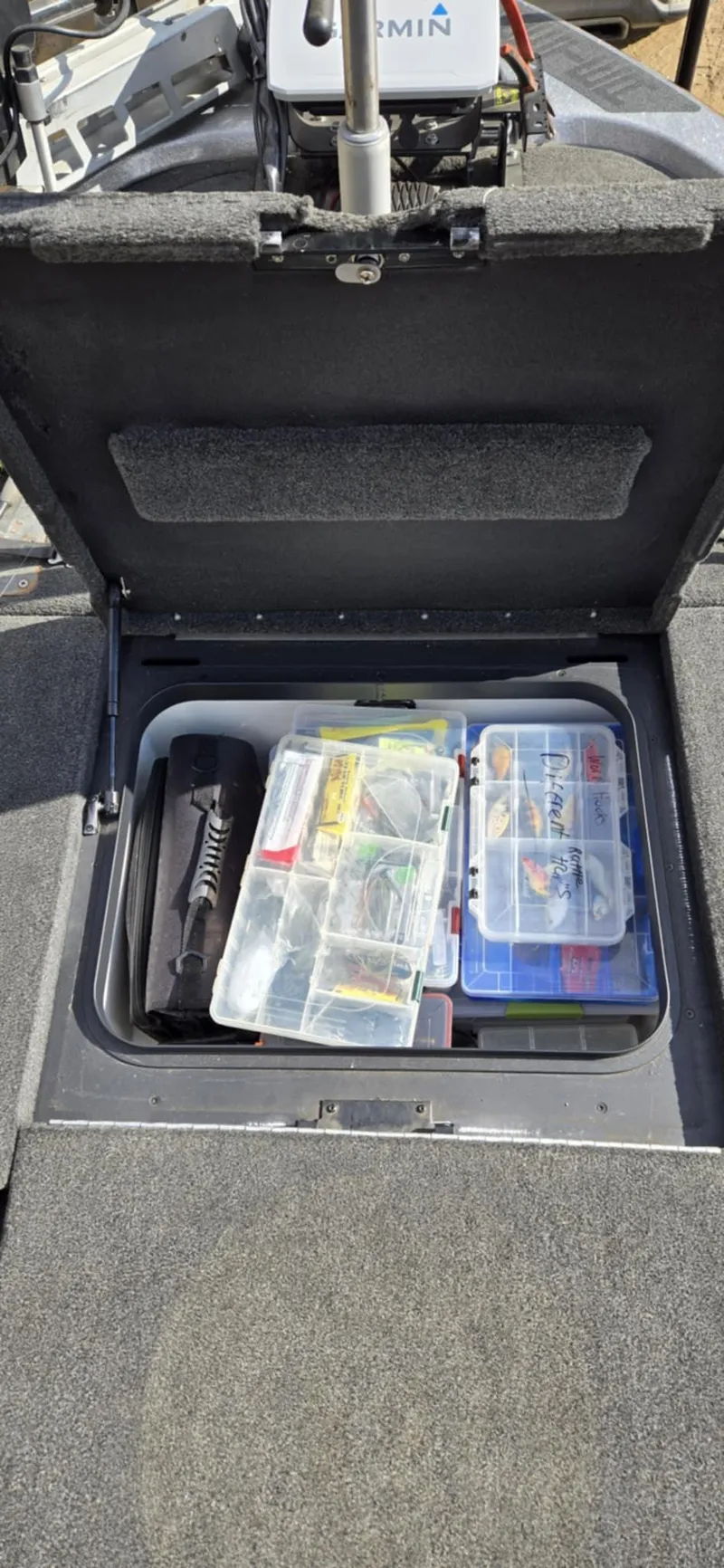 Slide: The Image of 2013 Skeeter ZX20 boat storage compartment with organized fishing gear and tackle boxes. - 15