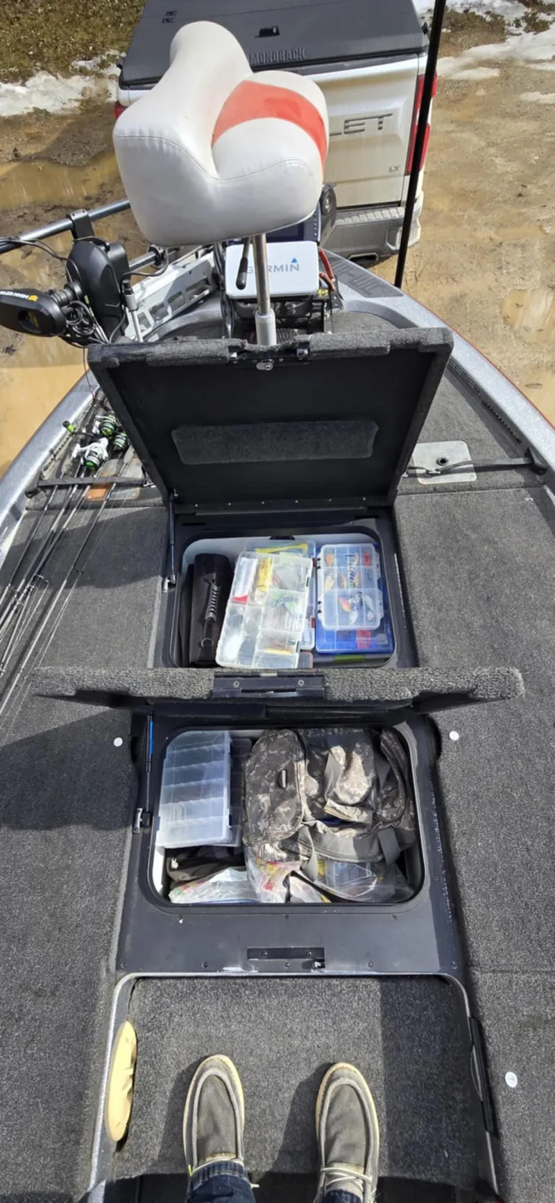 Slide: The Image of 2013 Skeeter ZX20 boat interior with storage compartments and fishing gear. - 18