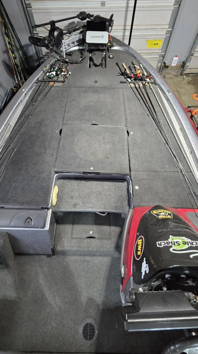 Slide: The Image of 2013 Skeeter ZX20 fishing boat deck with rods and equipment in a garage setting. - 5