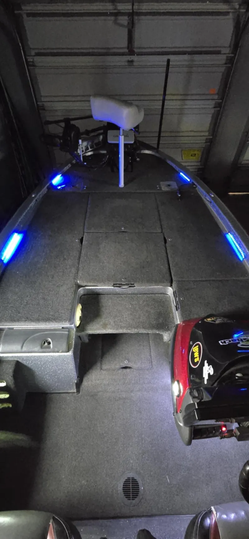 Slide: The Image of 2013 Skeeter ZX20 boat interior with blue LED lights in a garage. - 9