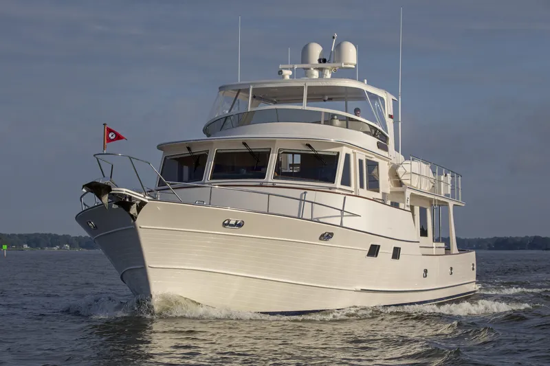 Slide: The Image of Luxury Fleming 78 yacht cruising on open water, 2027 model, elegant design. - 2