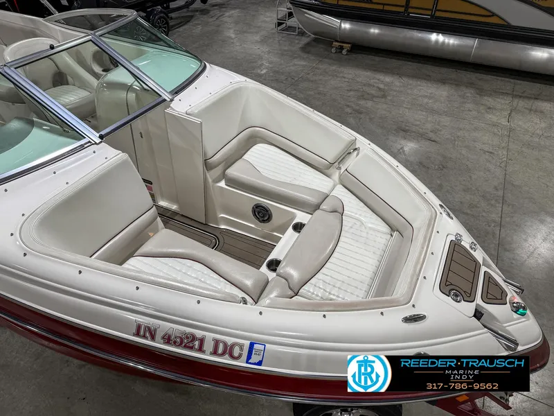 Slide: The Image of 2007 Bryant 240 boat with white interior and red exterior, displayed indoors. - 13