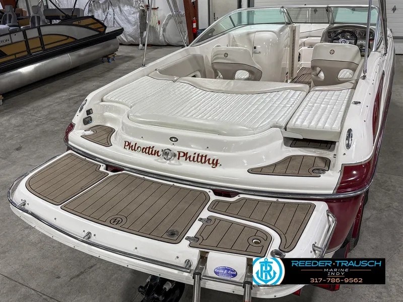 Slide: The Image of 2007 Bryant 240 boat with custom name "Phloatin Phluffy" in a showroom. - 14
