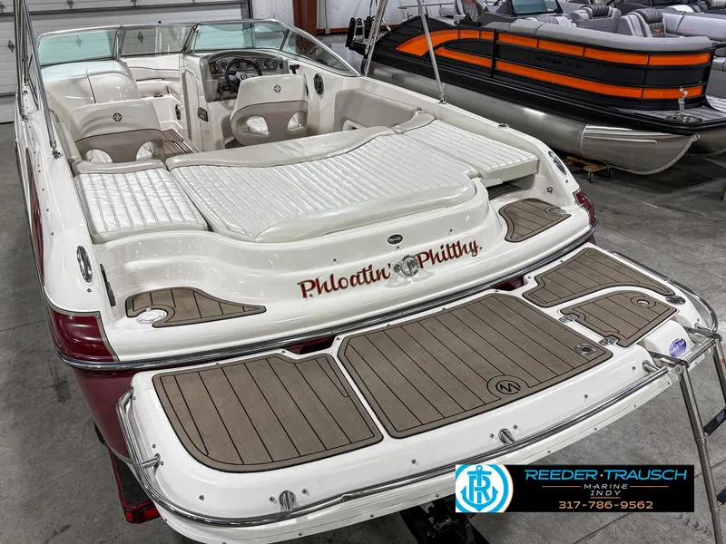 Slide: The Image of 2007 Bryant 240 boat with custom lettering, displayed indoors at Reeder-Trausch Marine. - 15