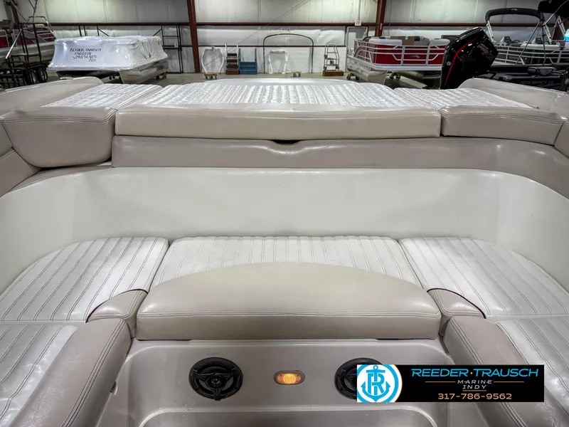 Slide: The Image of 2007 Bryant 240 boat interior with beige seating and cup holders. - 21