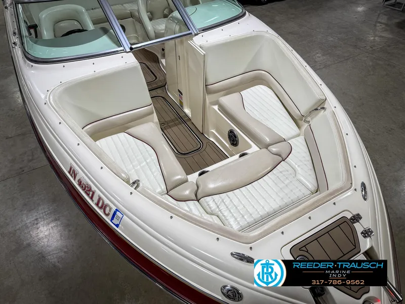 Slide: The Image of 2007 Bryant 240 boat with white and beige interior, showcased indoors. - 22