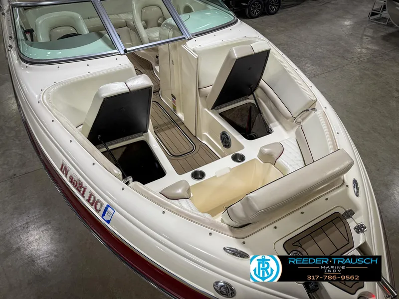 Slide: The Image of 2007 Bryant 240 boat interior with beige seating and wood accents in showroom. - 23