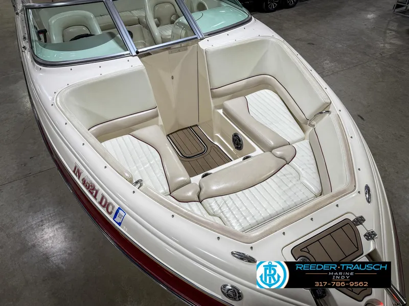 Slide: The Image of 2007 Bryant 240 boat with white and beige interior, showcased indoors. - 24