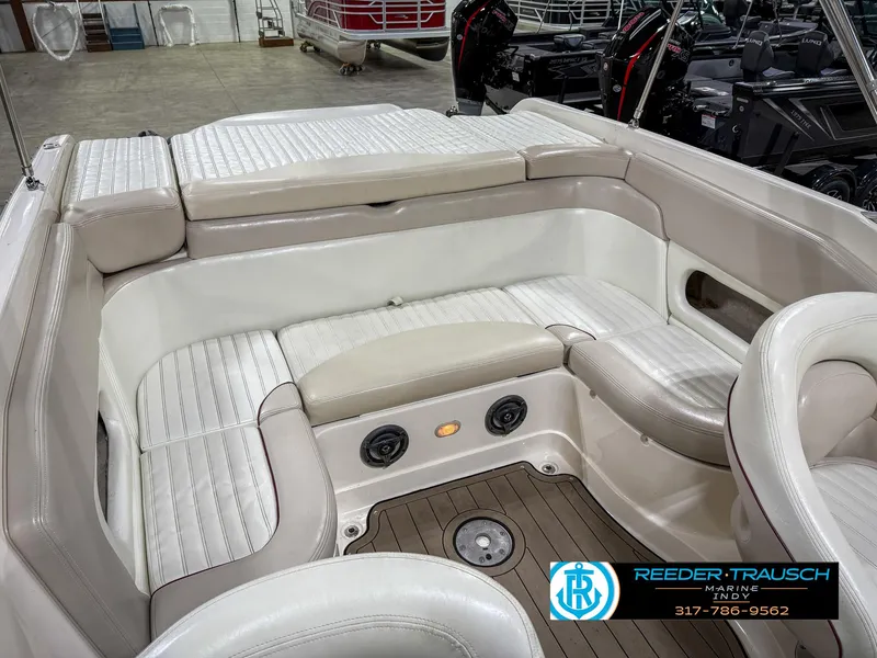 Slide: The Image of 2007 Bryant 240 boat interior with beige seating and wood flooring. - 27
