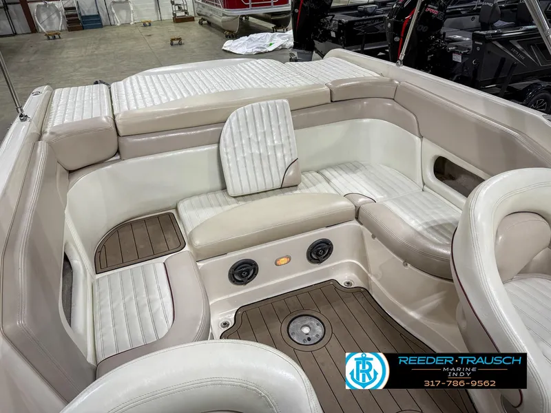 Slide: The Image of 2007 Bryant 240 boat interior with beige seating and wood accents. - 29