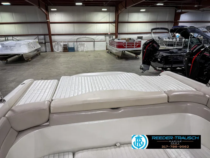 Slide: The Image of 2007 Bryant 240 boat interior with beige seating in a showroom. - 31