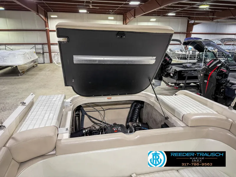 Slide: The Image of Open engine compartment of a 2007 Bryant 240 boat in a showroom. - 33