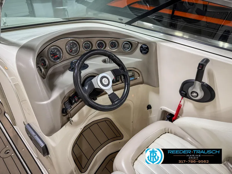 Slide: The Image of Bryant 240 boat dashboard, 2007 model, featuring steering wheel and control panel. - 34