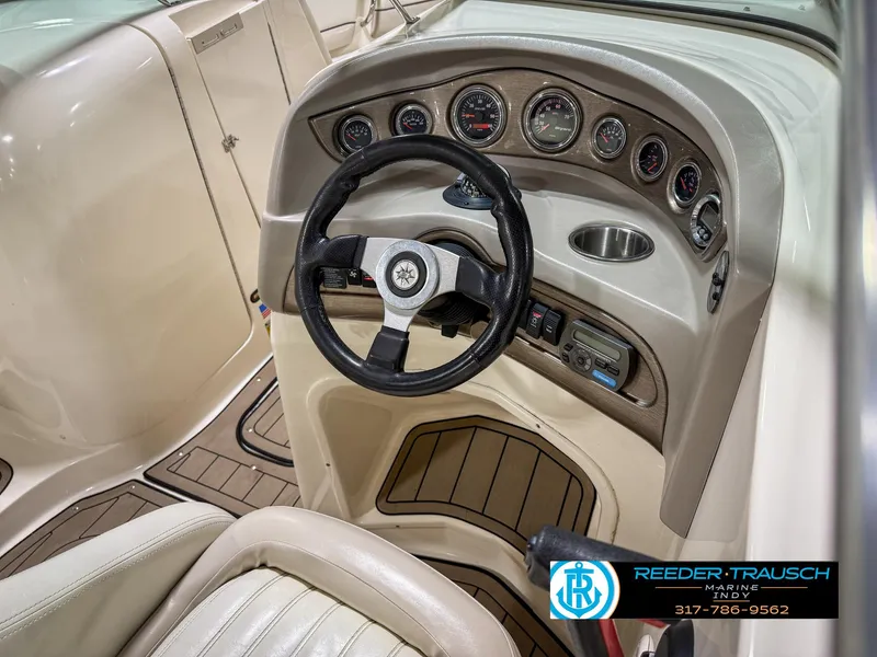 Slide: The Image of Interior view of a 2007 Bryant 240 boat dashboard with steering wheel and gauges. - 35