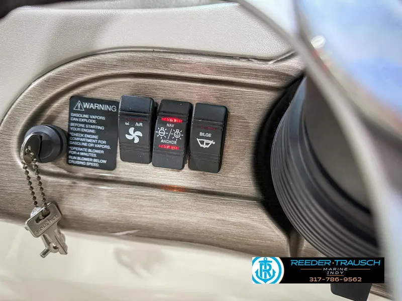 Slide: The Image of Control panel of a 2007 Bryant 240 boat with warning labels and keys. - 37