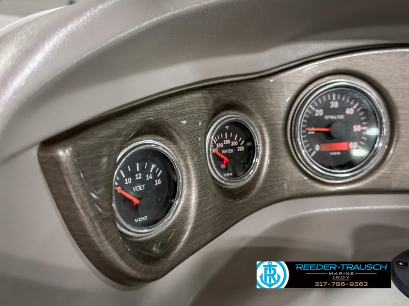 Slide: The Image of Dashboard gauges of a 2007 Bryant 240 boat, featuring voltmeter and temperature indicators. - 38