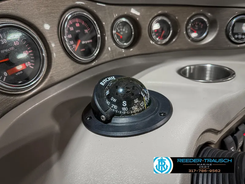 Slide: The Image of Dashboard of a 2007 Bryant 240 boat with compass and gauges. - 41