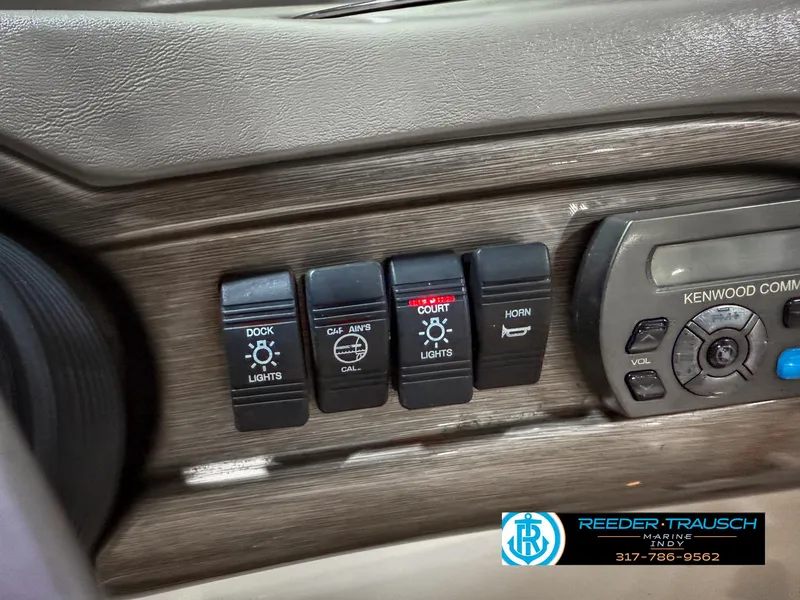Slide: The Image of Control panel of a 2007 Bryant 240 boat with light and horn switches. - 43