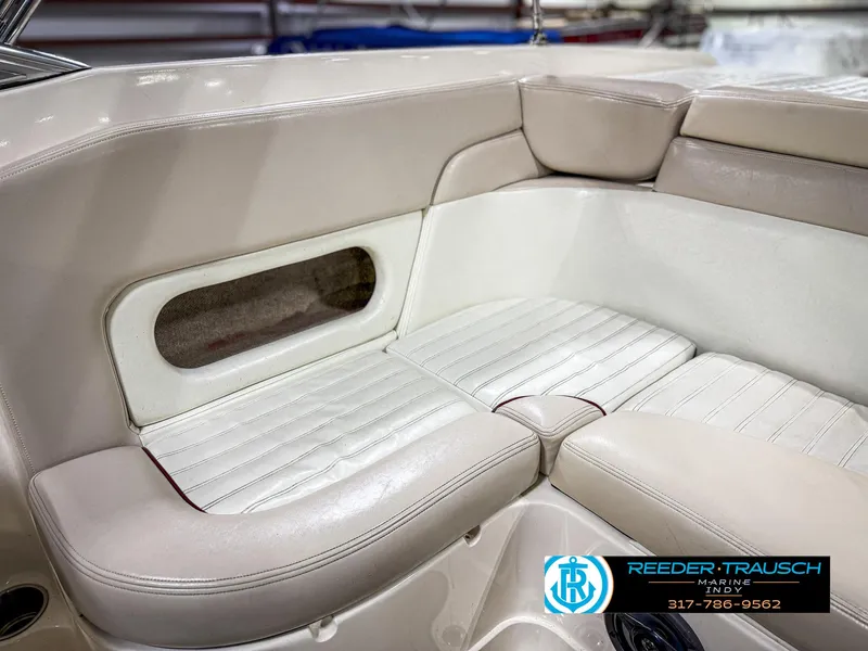 Slide: The Image of 2007 Bryant 240 boat interior with beige leather seating and storage compartment. - 48