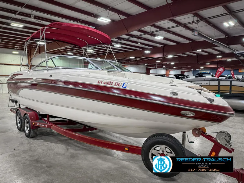 Slide: The Image of 2007 Bryant 240 boat with red accents on a trailer in an indoor showroom. - 6