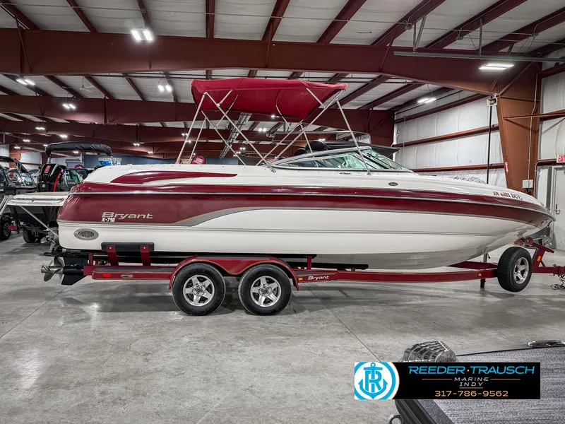 Slide: The Image of Red and white 2007 Bryant 240 boat on trailer in indoor showroom. - 7