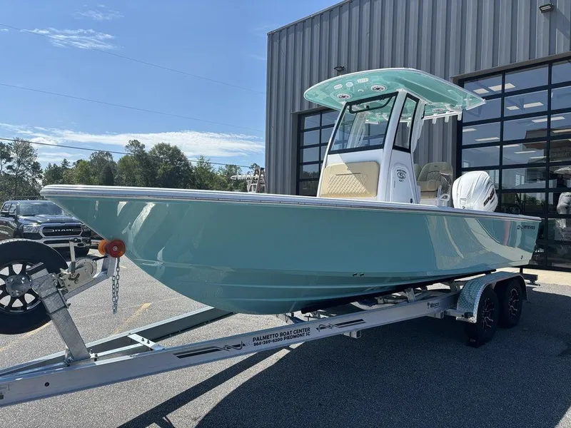 Slide: The Image of 2026 Sportsman Masters 227 Bay Boat on trailer, parked outside a building. - 11