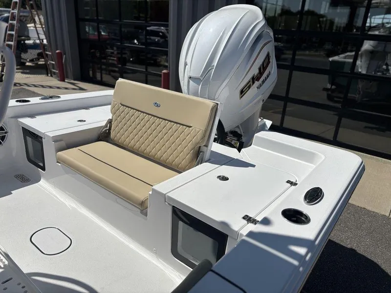Slide: The Image of 2026 Sportsman Masters 227 Bay Boat interior with beige seating and steering console. - 15