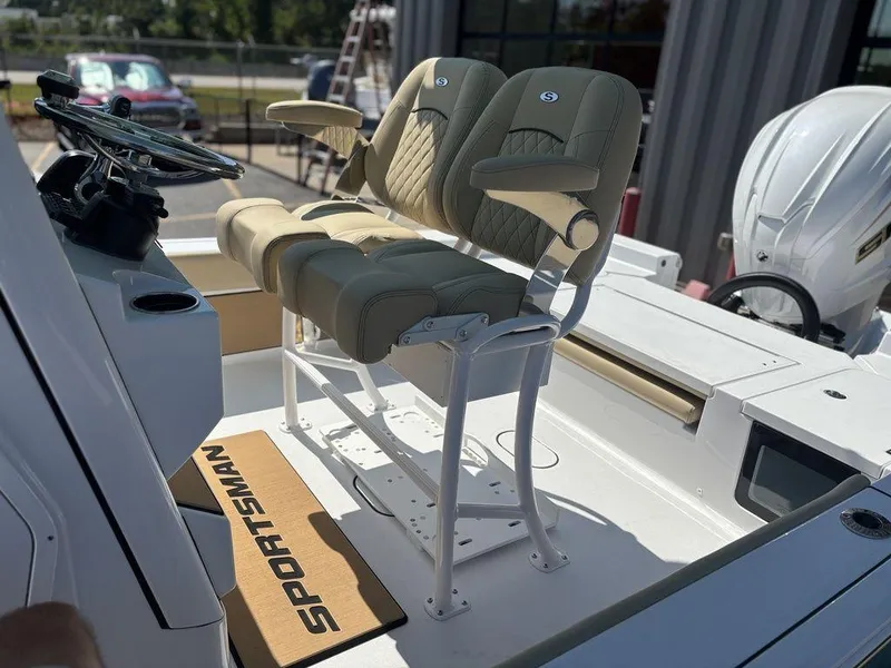Slide: The Image of 2026 Sportsman Masters 227 Bay Boat on trailer, parked outside a building. - 16